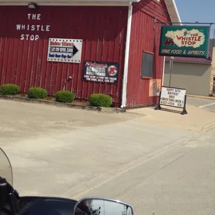 a motorcycle parked in front of a red building