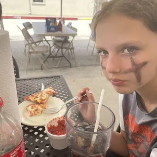 A psycho eating pizza with a fork