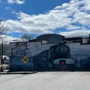 a train painted on the side of a building