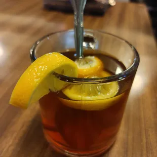 a cup of tea with a lemon wedge