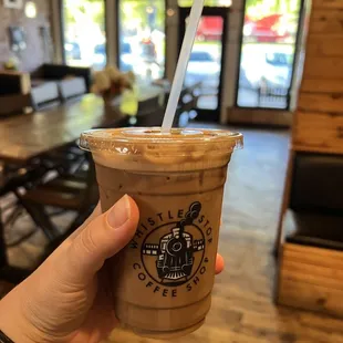 a hand holding a cup of coffee
