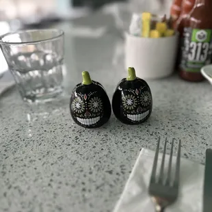 two pepper shakers on a table
