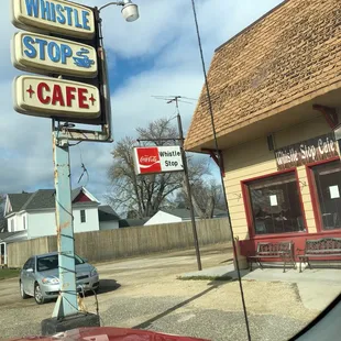 a car parked in front of a cafe