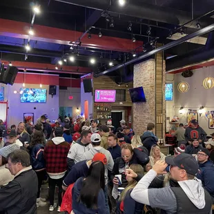 a large group of people eating and drinking