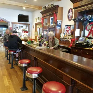 Bar seating with the owner doing her thing.