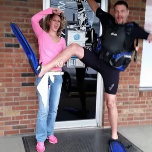 a man and a woman standing in front of a door