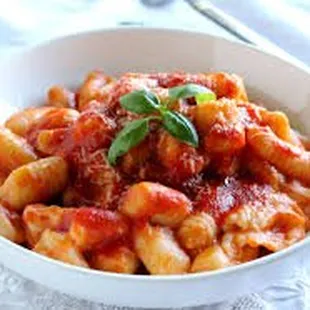 a bowl of pasta with tomato sauce
