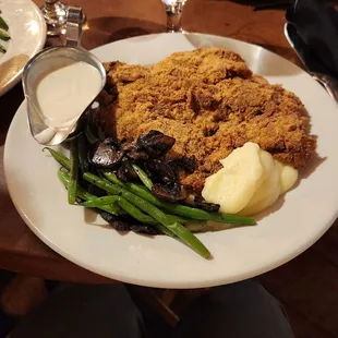 Chicken fried steak, gravy, green beans and mushrooms, mashed potatoes