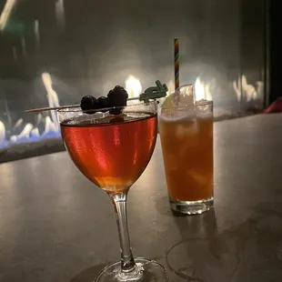 two cocktails on a bar