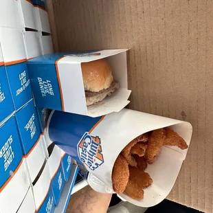 a person opening a box of doughnuts