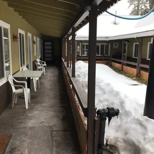 covered porch with snow