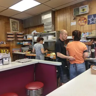 a man and woman in a kitchen