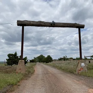a dirt road leading to a farm