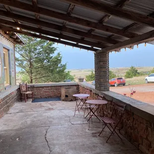 a patio with tables and chairs
