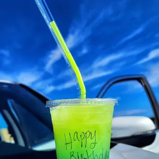 a blue and green drink with a straw