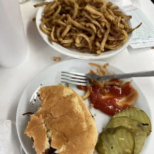 a plate of food with a sandwich and pickles