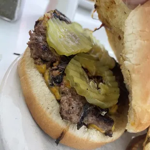 a hamburger with pickles and onions