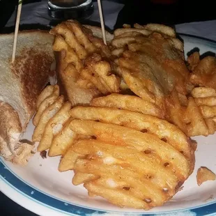Triple grilled cheese with waffle fries.
