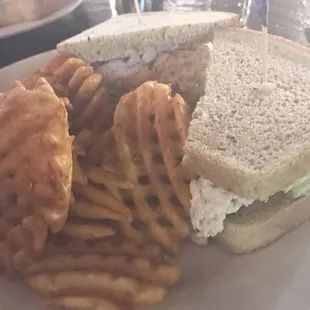 Tuna salad sandwich with fries.