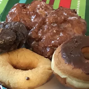Clockwise starting at 12 is the apple fritter, chocolate iced yeast, plain cake donut, then chocolate cake donut.