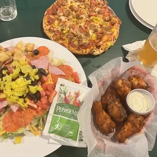 The Italian Stallion pizza, buffalo wings and salad.