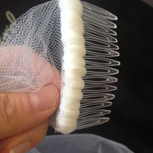 Cheap plastic brooch compared to a nice metal one in the real veil.