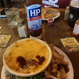 Cottage pie with brown sauce and chips and peas. Yum!