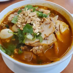 Tom yum noodle soup with thick white flat noodles - sweet and sour broth. My go to order here.