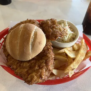 Pork tenderloin sandwich with steak fries and coleslaw