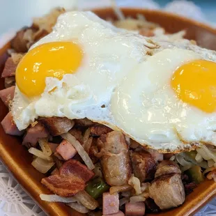 two fried eggs on top of hash browns