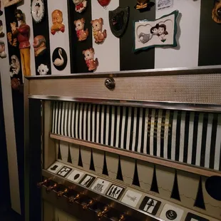a piano in a room with black and white striped walls