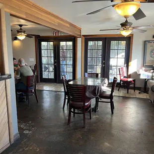 a dining area with tables and chairs