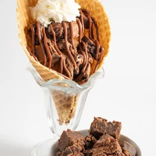 a waffle cone with ice cream and chocolate fudges