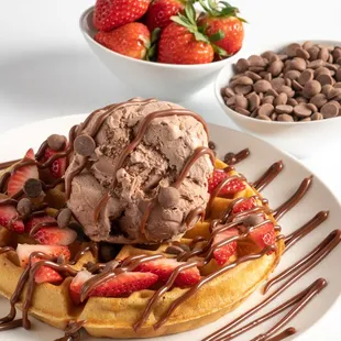 a waffle with chocolate ice cream and strawberries