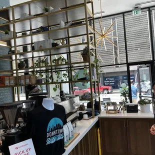 a woman standing in a coffee shop