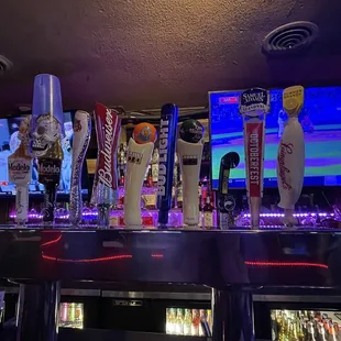 a row of beer taps on a bar