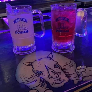 two glasses of beer on a bar