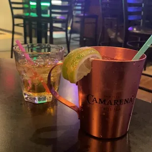 a copper mug with a lime wedge and a drink in it