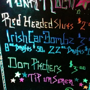 a chalk board with neon writing