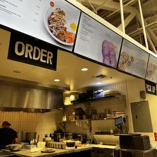 a restaurant kitchen with menus on the wall