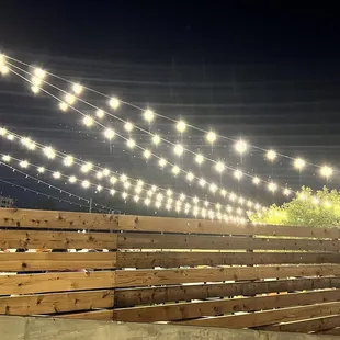 a wooden deck with string lights