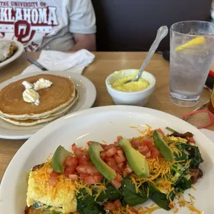 Breakfast omelette. With grits and pancakes.  All comes with it yummy.