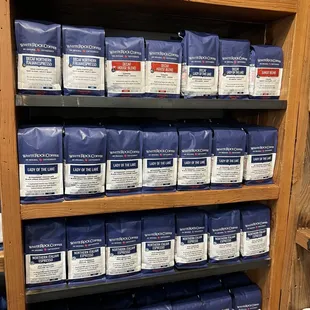 a shelf of coffee packages