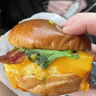 Breakfast sandwich is delicious. Egg cheese bacon spinach pesto