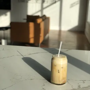 a glass of iced coffee on a table