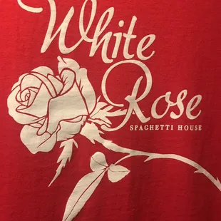 a red t - shirt with a white rose on it