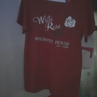 White Rose t-shirts for sale in restaurant. Hanging above the bar.