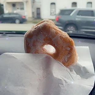 a doughnut on a napkin in a car