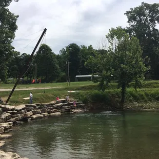 people sitting on rocks by the water