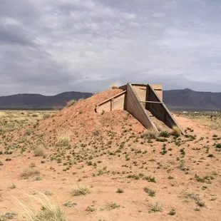 The bunker that housed cameras used to document the first nuclear test. Ground zero is in the background.